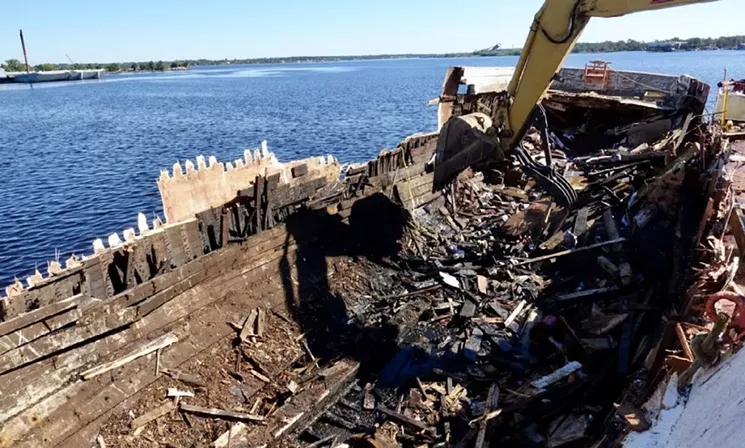 An Oil Spill Response Organization uses an excavator to demolish a fishing vessel. - PHOTO BY MICHAEL HIMES/COURTESY OF U.S. COAST GUARD