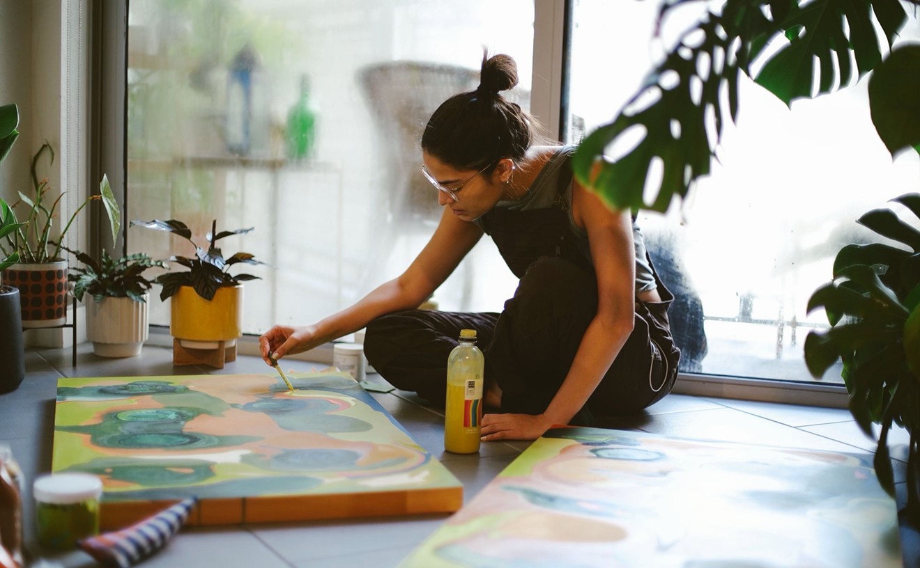 The artist paints in her home studio.