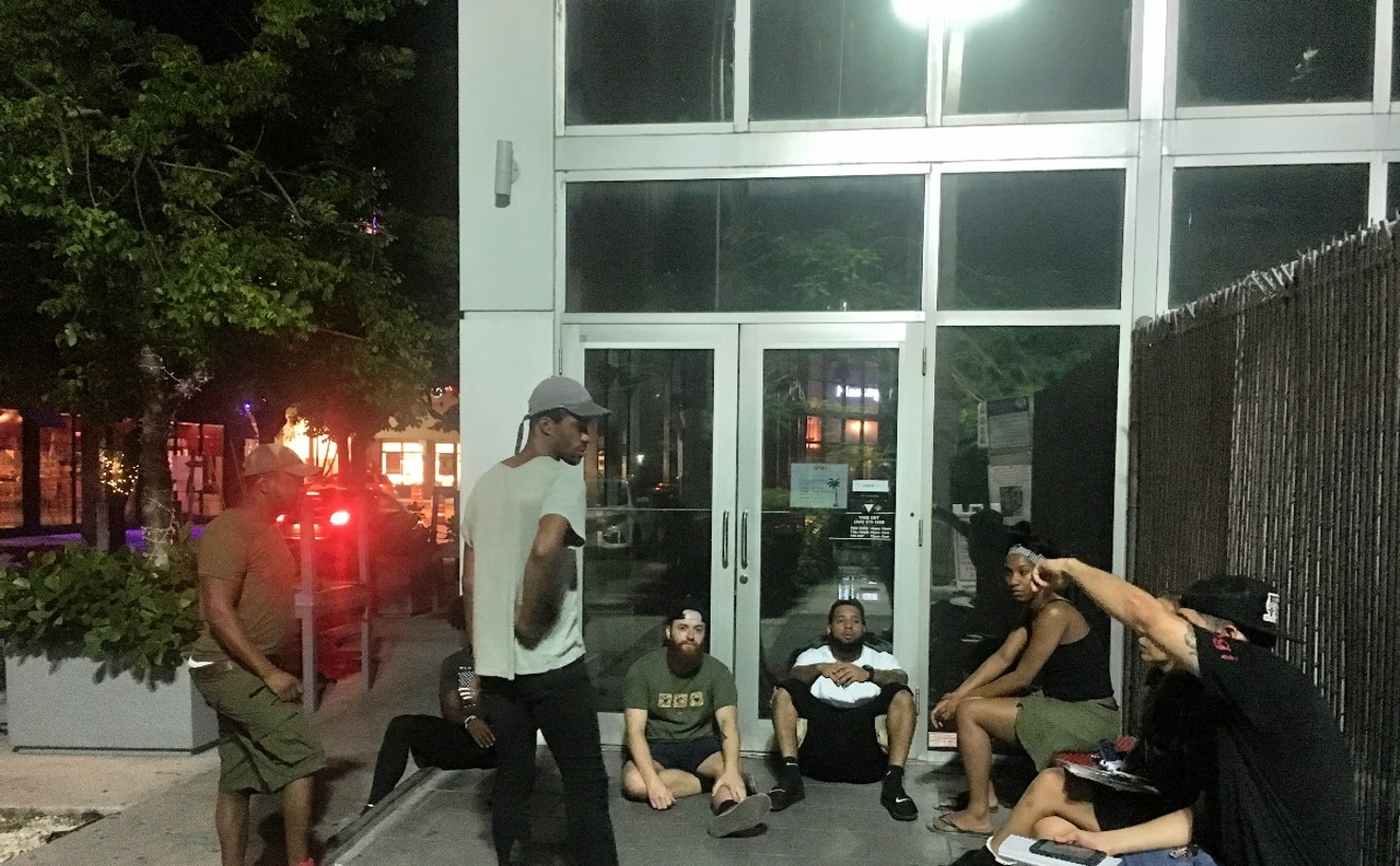 Workers sit outside a shuttered Gigi.