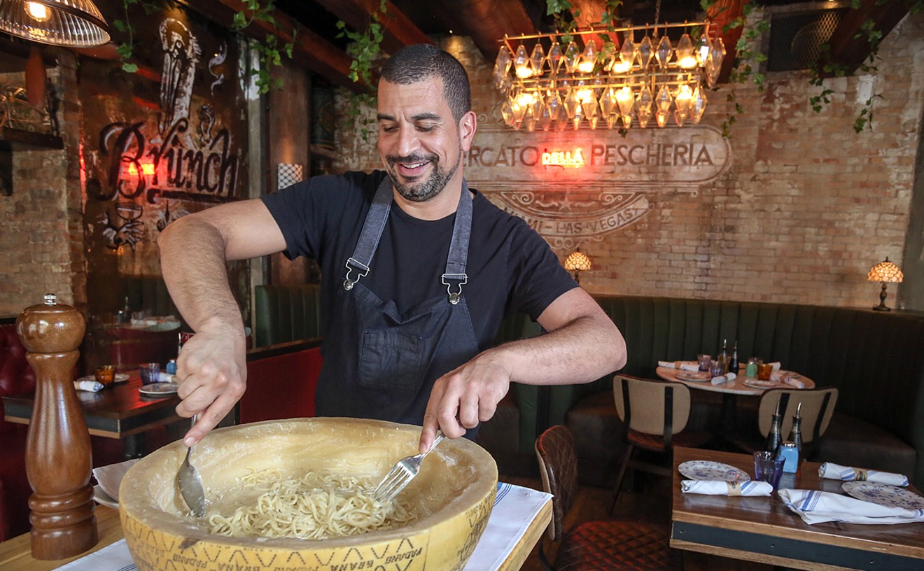 Mercato Della Pescheria corporate chef Alex Martinez makes cacio e pepe in a wheel of Pecorino Romano cheese.