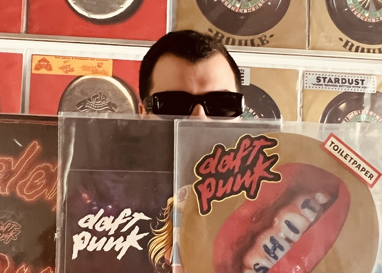 Fruit Fly Records owner Giovanni Hanna poses with a few records from his Daft Punk collection.