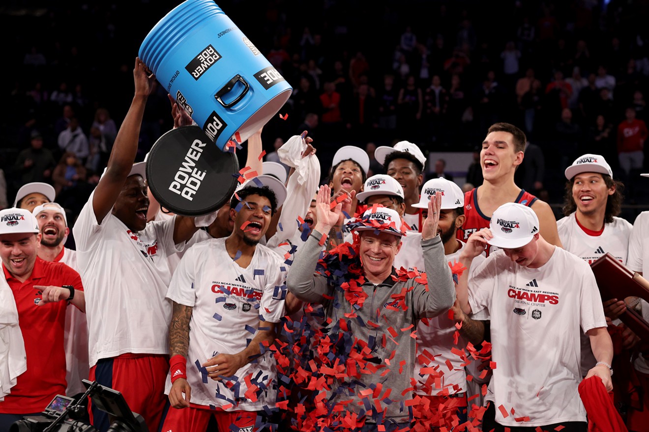 Head coach Dusty May of the FAU Owls celebrates with the team after beating Kansas State in the NCAA Men's Basketball Tournament on March 25, 2023.