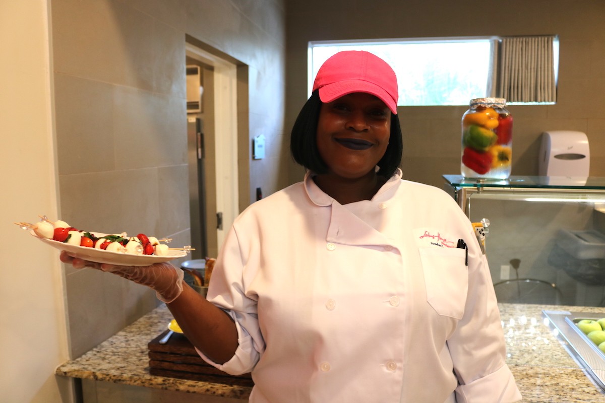 Luciana Lamont serving mozzarella and tomato bites at the announcement of the Centner Foundation's $2 million gift to Lotus House.