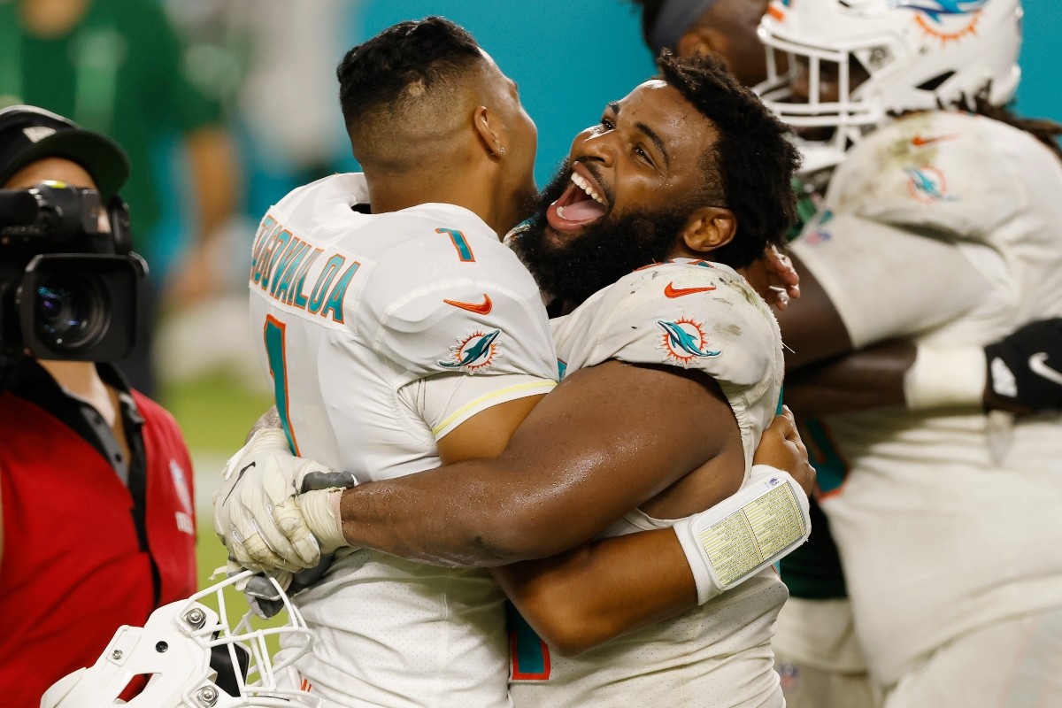 Christian Wilkins celebrates with Tua Tagovailoa after he made his NFL debut against the New York Jets.