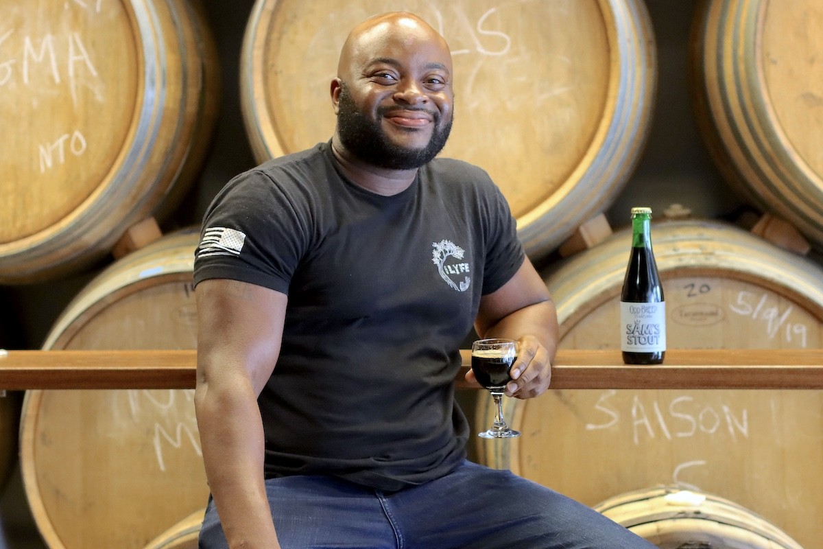 Savage Lyfe Beer Co. founder/head brewer Sam Phanor with his latest collaboration beer dubbed "Sam's Stout"