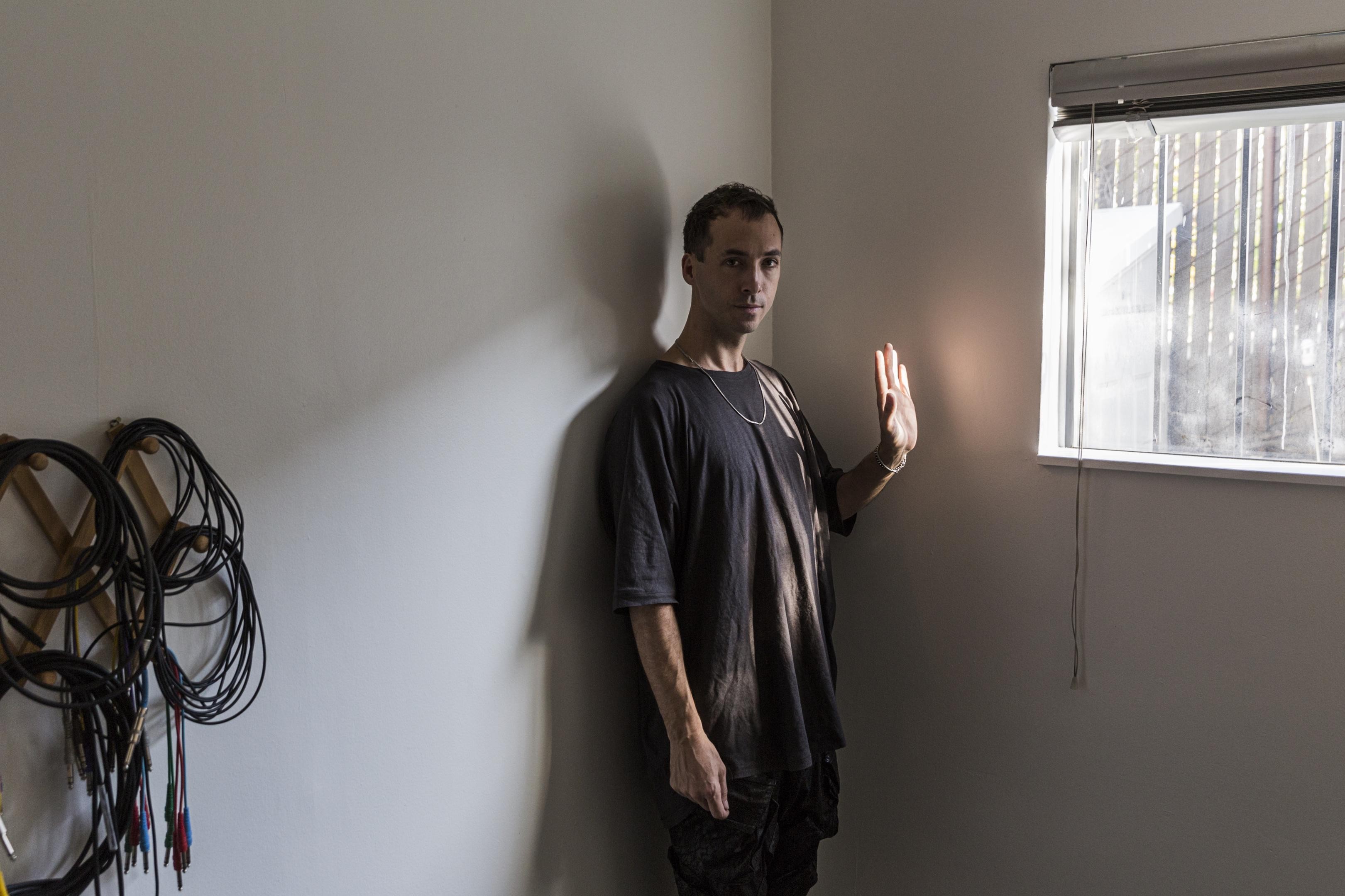 Grayscale photo of man standing near window photo – Free Cloud