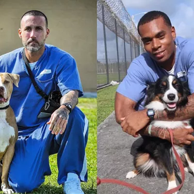 Trainers Pete (left) and Oscar (right) with their dogs, Gauge and Duke