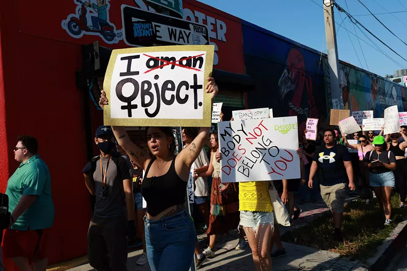 Image: Abortion rights protesters holding signs march in Florida