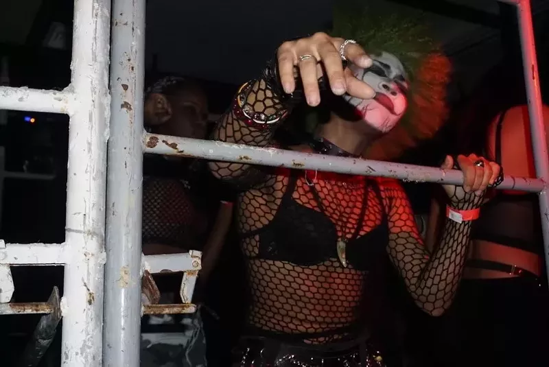 Image: A woman in clown makeup dancing