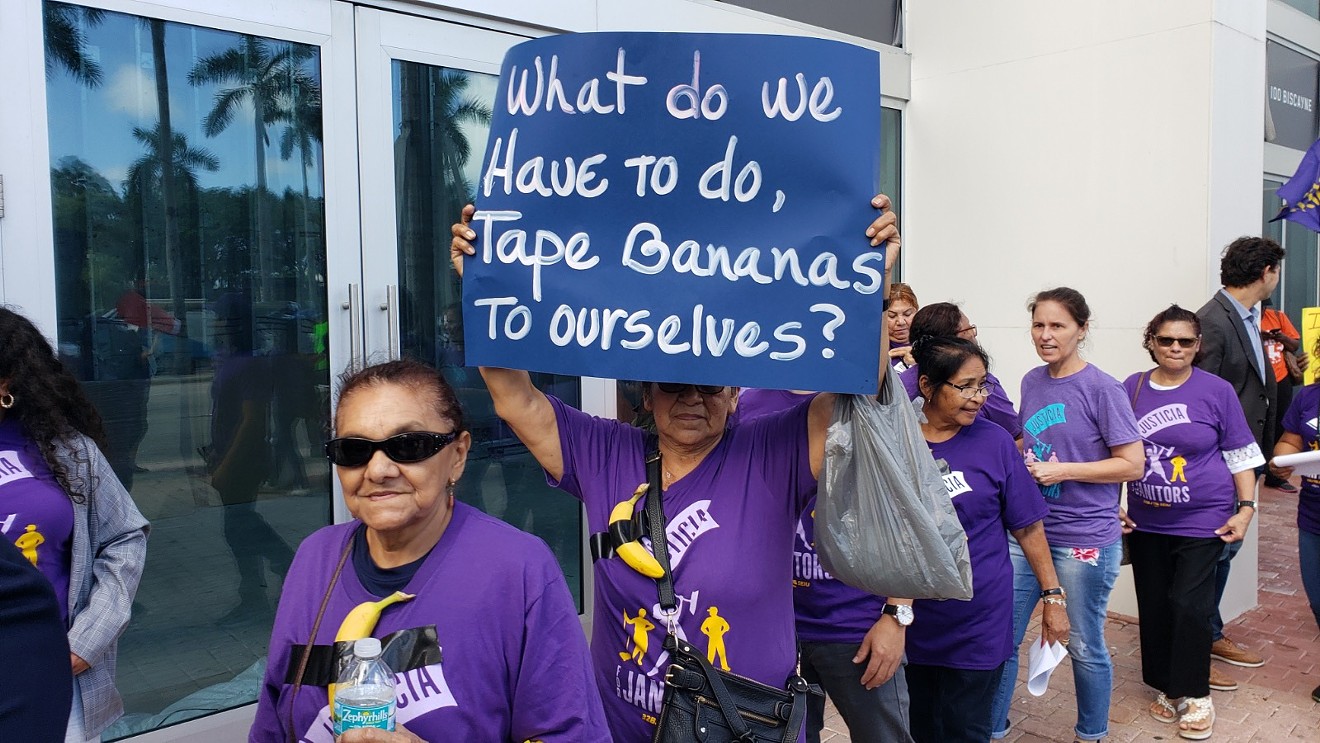 Janitors with bananas taped to purple union shirts took to the streets of downtown Miami Wednesday afternoon to protest low wages and working conditions in an industry rife with abuse and intimidation.