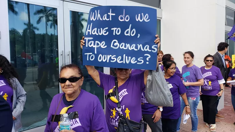 Image: Janitors with bananas taped to purple union shirts took to the streets of downtown Miami Wednesday afternoon to protest low wages and working conditions in an industry rife with abuse and intimidation.