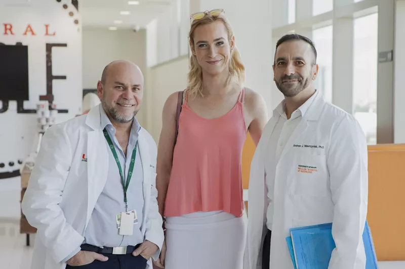 Image: Researchers Allan Rodriguez and Andrew Wawrzyniak pose for a photo with participant Madison Waldron.