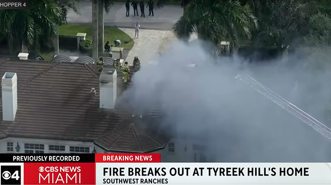 Smoke billows from a fire at an NFL player's mansion