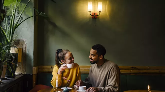 A couple starring at each other in a coffee shop