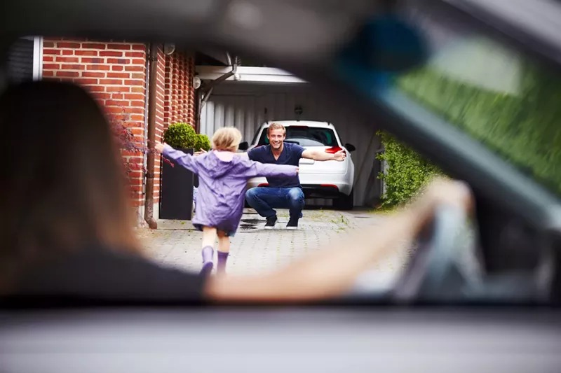 Image: Child running excitedly toward a man