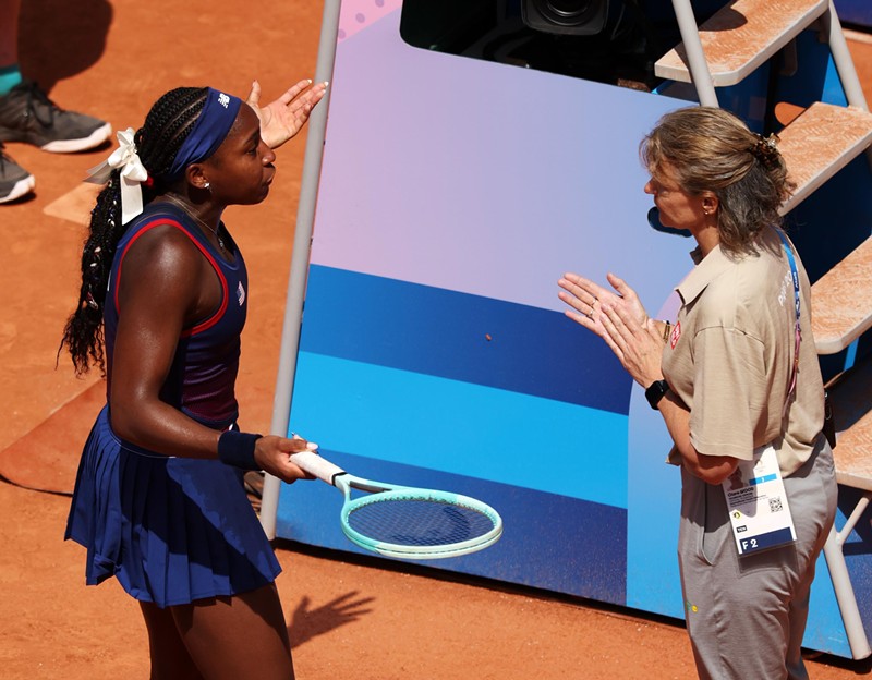 Coco Gauff argues with a tennis official following a dispute with the chair umpire during her third-round Olympic match against Donna Vekić of Croatia at Roland Garros on July 30, 2024, in Paris, France.