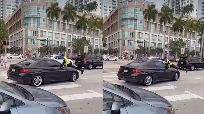Cell phone video shows a Miami police officer clinging to the hood of a man's car while firing shots through the windshield.
