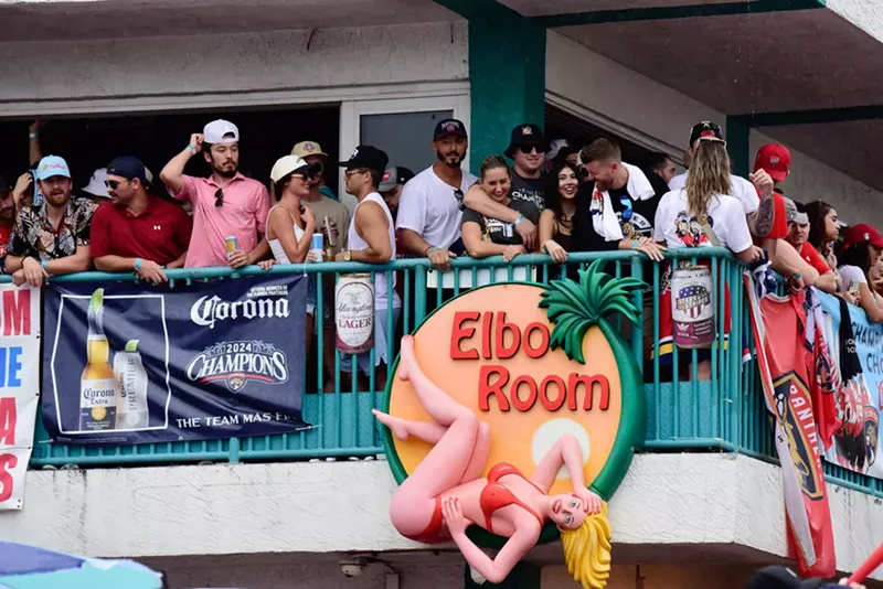 Image: Florida Panthers fans stand alongside the second-story railing at Elbo Room in Fort Lauderdale during the 2024 parade