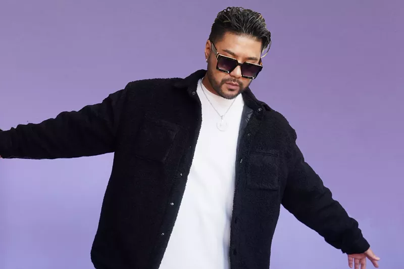 Image: Portrait of Wax Motif against a purple background
