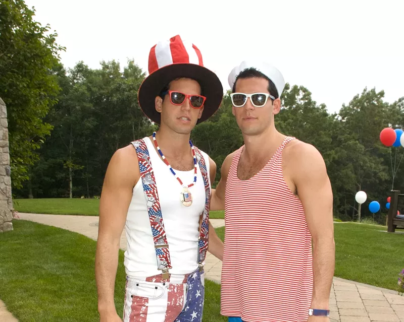 Image: The Alexander twins dressed in patriotic costumes outside a large mansion