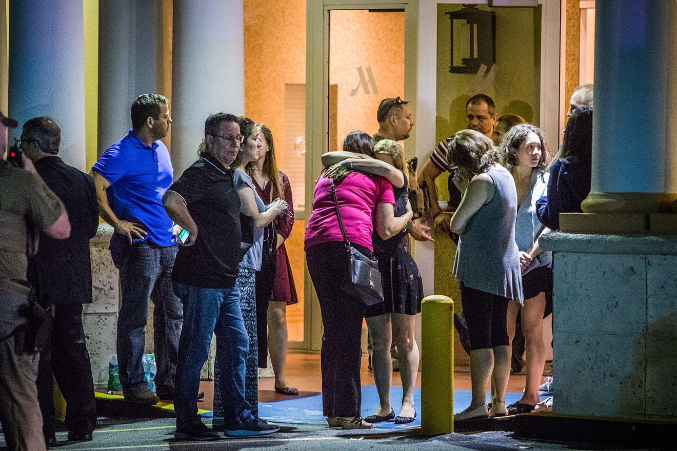 Locals hug after the school shooting in Parkland Wednesday.