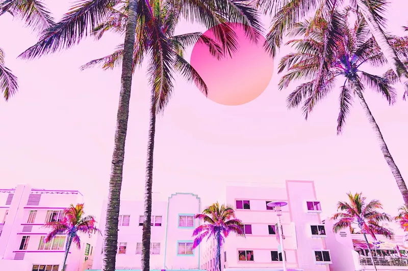 Image: Dreamy picture of Miami Beach Ocean Drive hotelscape with neon colors and big sun