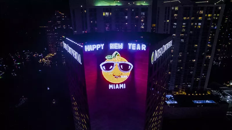 Image: Neon orange caricature on the side of the InterContinental Hotel in Miami