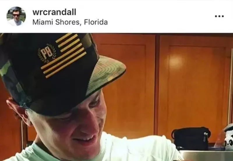 Image: A screenshot of a now-deleted Instagram post showing Crandall wearing a hat with the Proud Boys' logo.