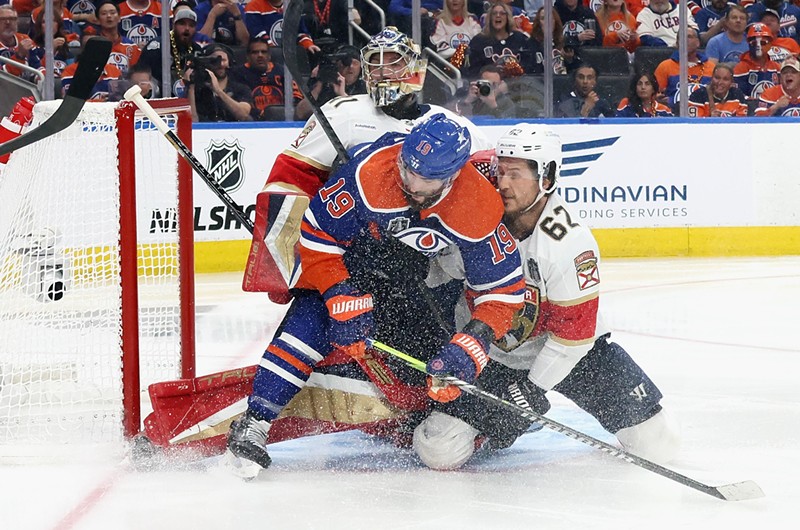 Brandon Montour of the Florida Panthers defends against Adam Henrique of the Edmonton Oilers in Game Four of the 2024 Stanley Cup Finals in Edmonton, Alberta.