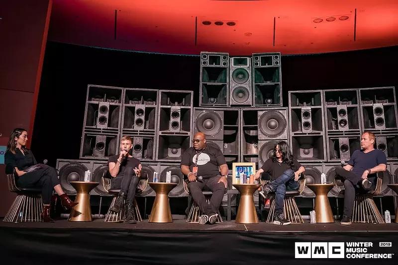 Image: Richie Hawtin, Carl Cox, and others onstage during a panel at Winter Music Conference 2019