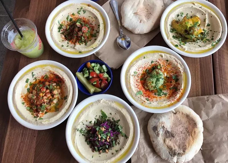 Image: Dizengoff's hummus, pita, and pickles.