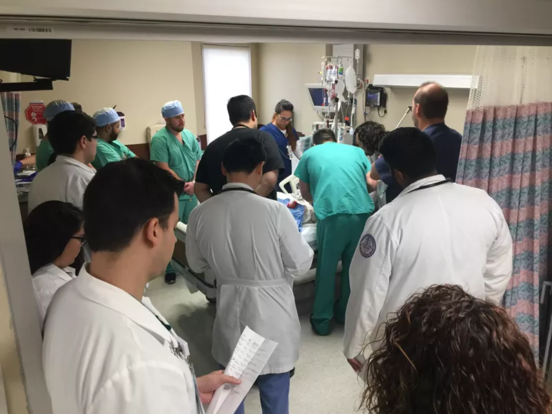 Image: Doctors and nurses crowd around Choeun Nuon after a botched procedure in 2017.