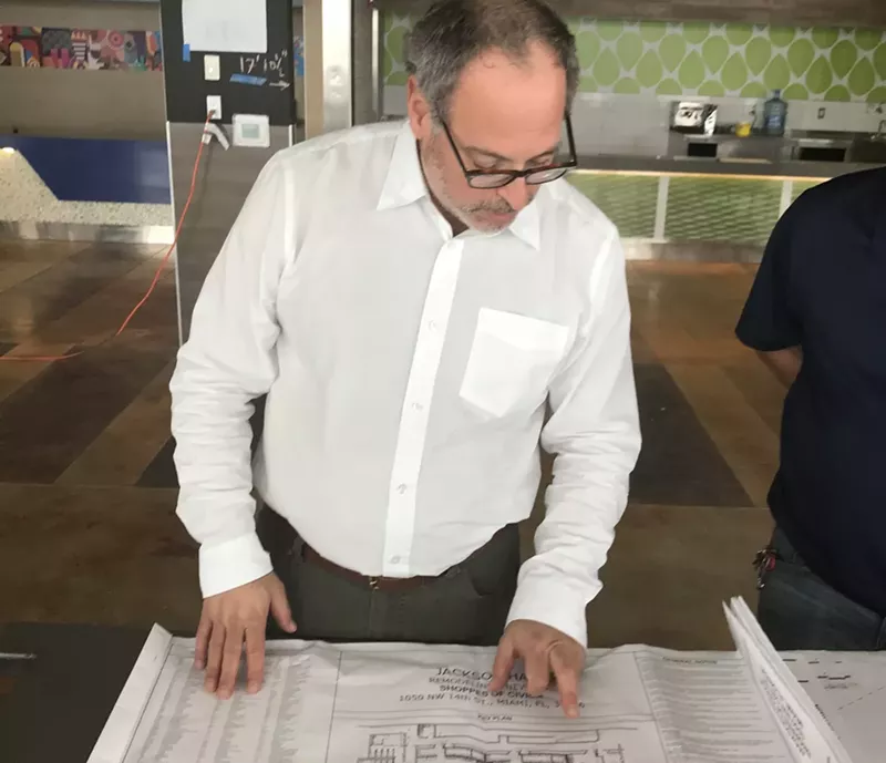 Image: Jackson Hall partner Ken Lyon with Jackson Hall plans.