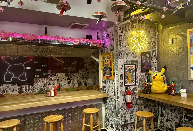 Anime-inspired decorations and neon signs fill the dining room of Kitsune House.