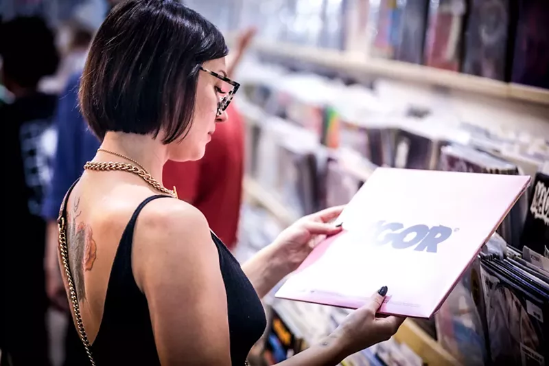 Image: You can still shop in-store for Record Store Day 2020, but unlike this shopper of the past, you'll have to wear a mask.